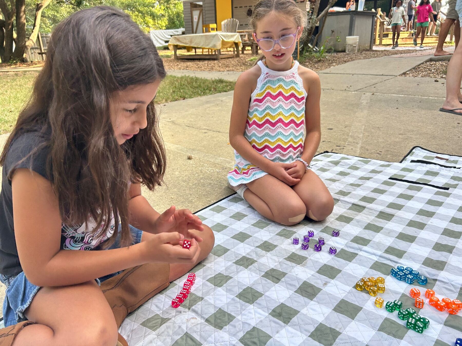 A dice game on a picnic blanket