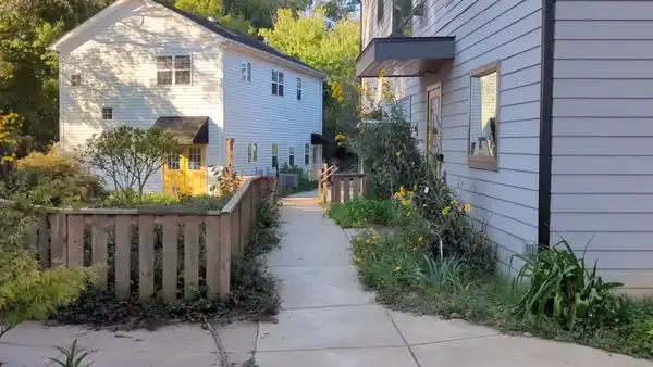 Walking up the garden path to the yellow door